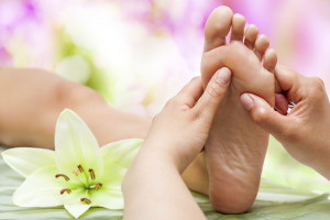 Therapist hands massaging foot.